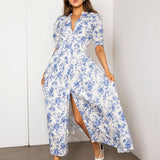 Woman wearing a blue floral dress against a white wall