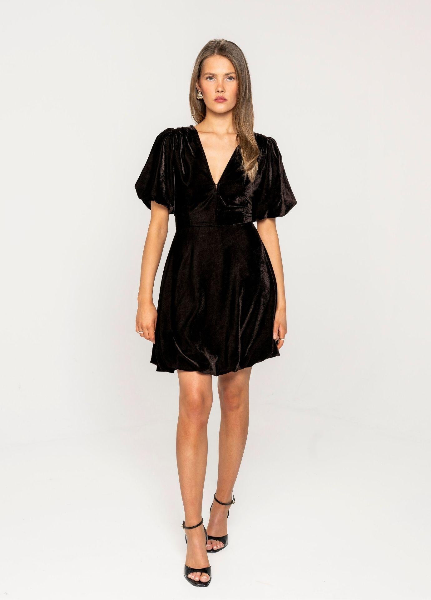 Blake Dress Velvet Toffee in a full length front view in a light grey studio, showing the V-neckline and the puff sleeves.