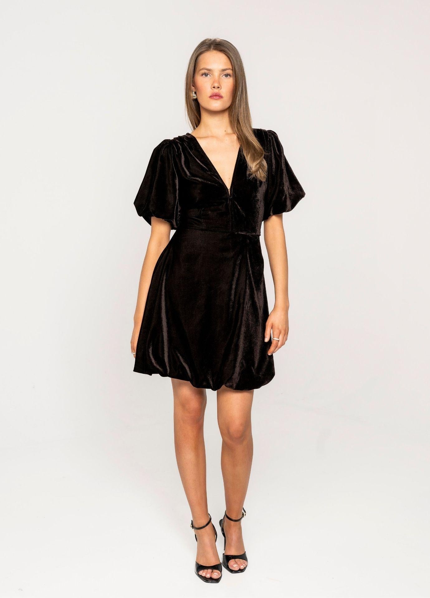 Blake Dress Velvet Toffee in a full length studio view, showing the balloon skirt and black strappy heels against a light grey background.
