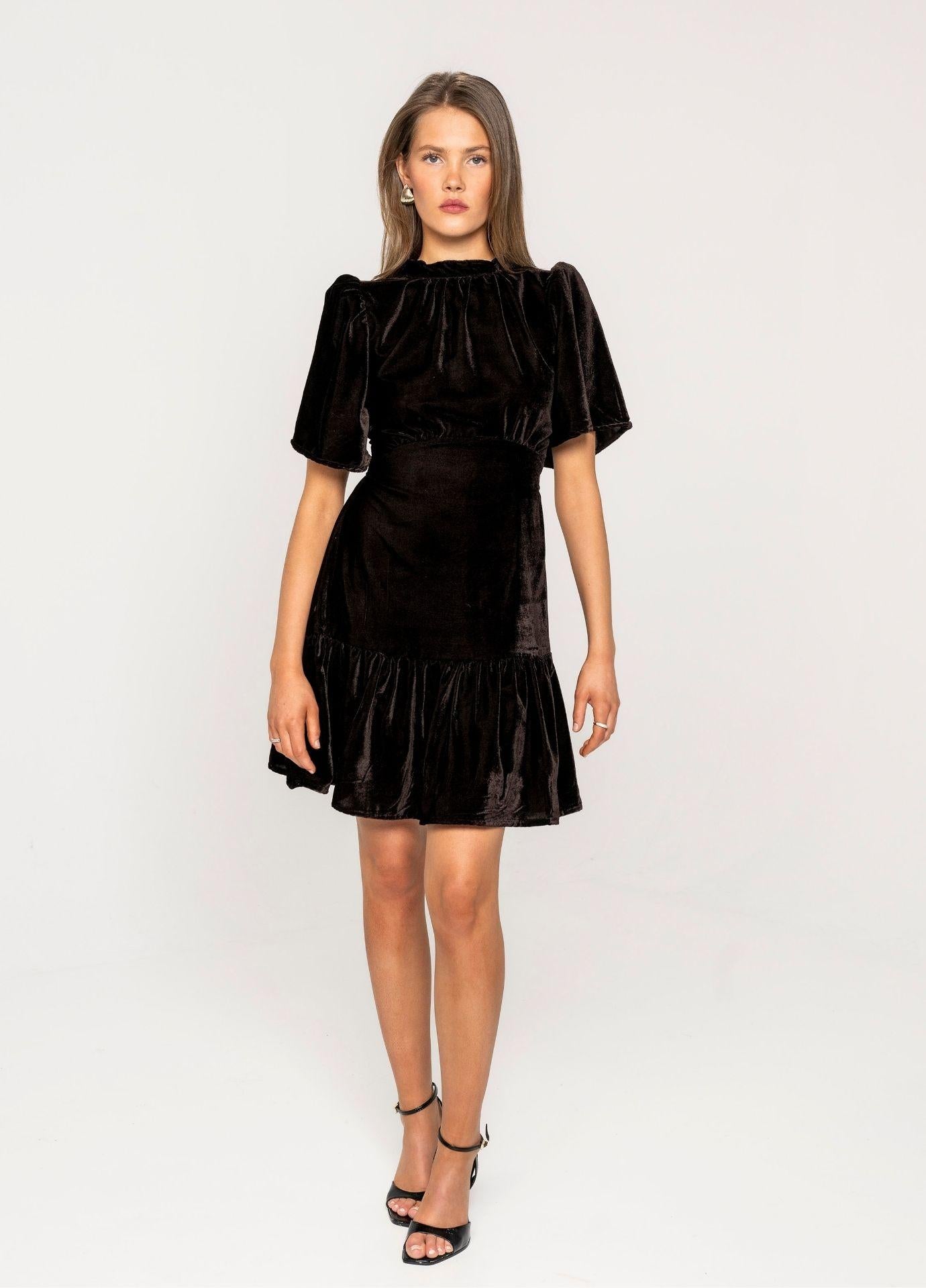 Jolie Dress Velvet Toffee in a full length studio front view, showing the fitted bodice and the ruffled mini hem.