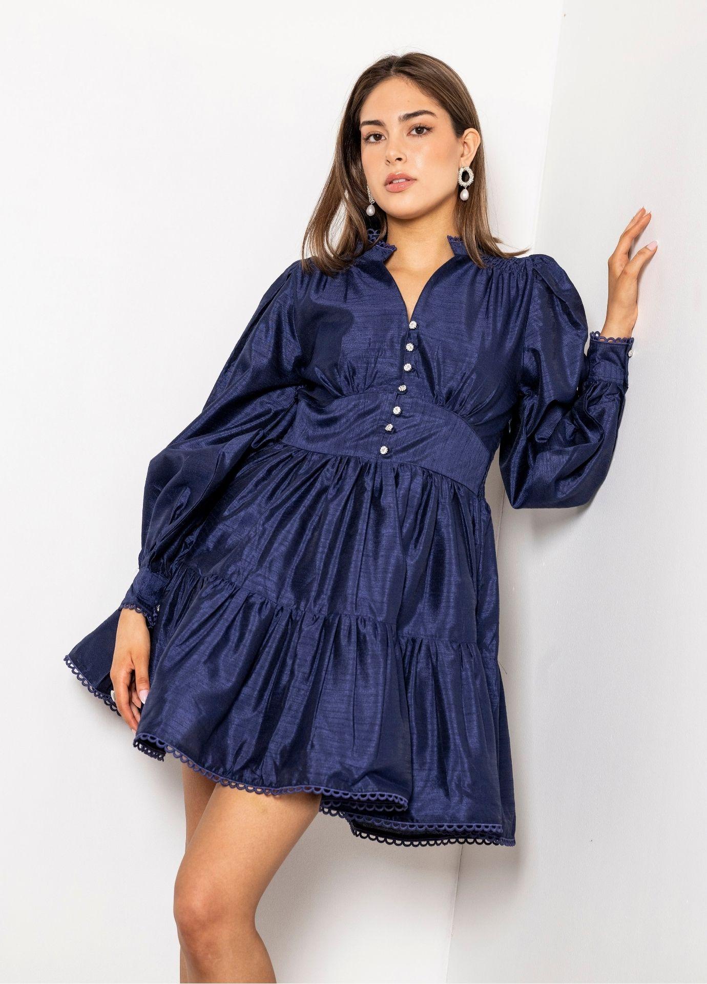 Primrose Dress Evening Blue with the model twirling, showing the tiered skirt and the delicate lace trim along the hem.