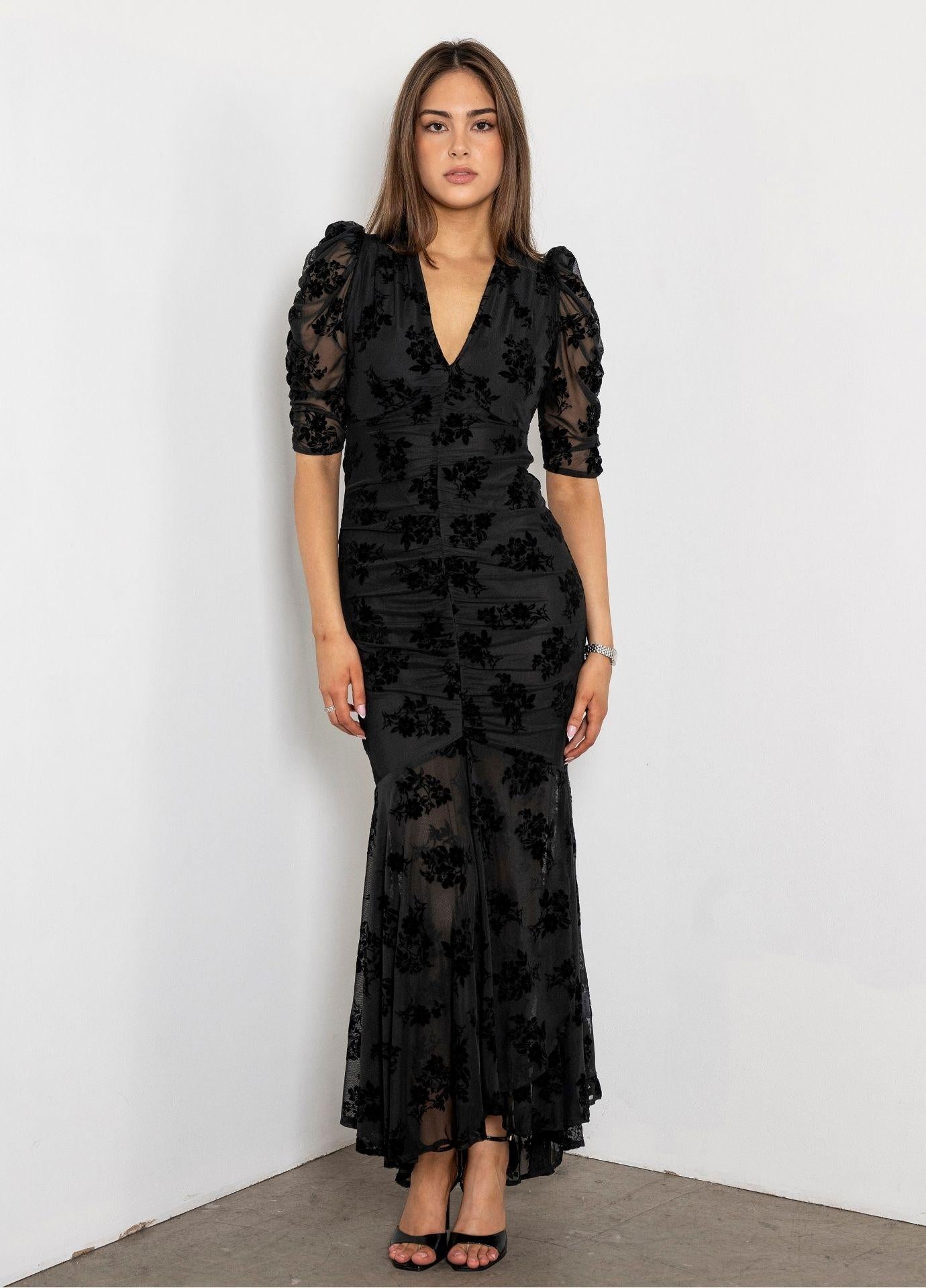 Sofia Dress Blooming Mesh in a full length front view in a white studio corner, showing the ruched body and the flared hem of the floral mesh dress.