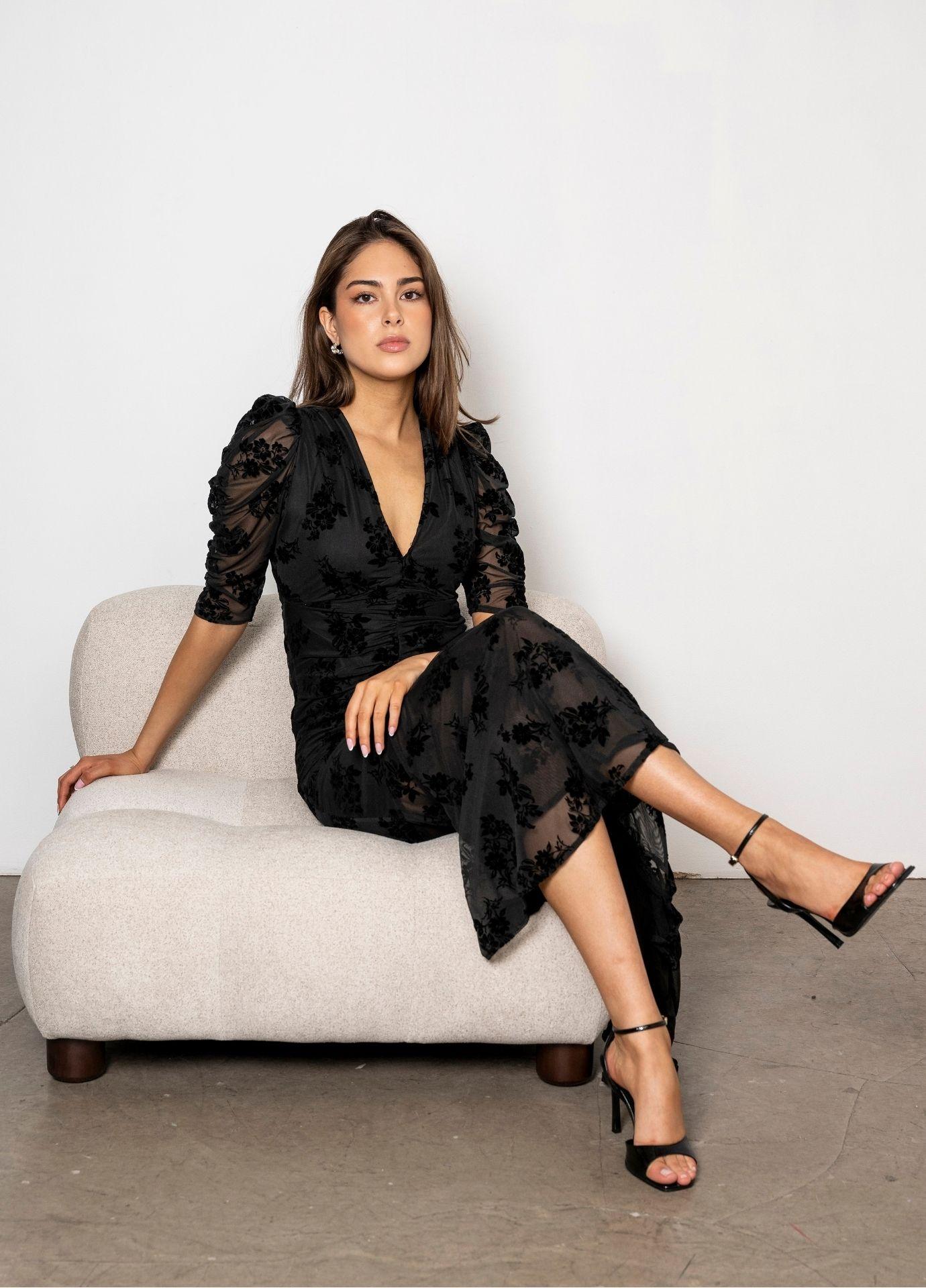 Sofia Dress Blooming Mesh with the model seated with her legs crossed, showing the tone on tone flowers and the sheer flared hem.