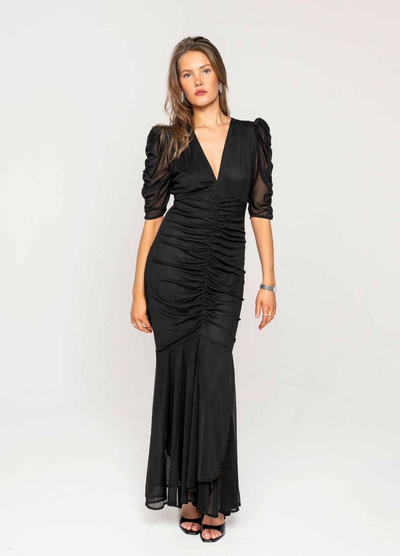 Sofia Dress Night Black Mesh in a full length studio front view, showing the ruching down the body and the sheer flared hem at the ankle.
